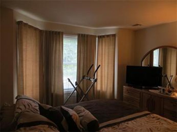 55 A Windham Road, Unit 1 Hudson, NH 03051 - Photo 10 of 24 a living room with furniture and a flat screen tv