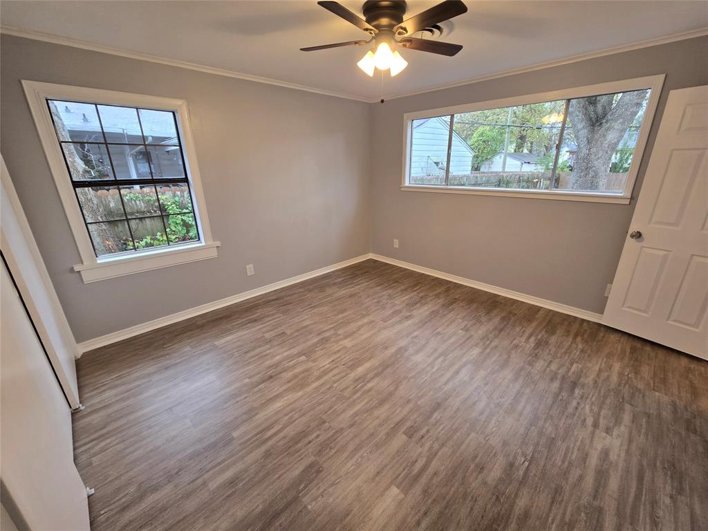 233 Roma Drive Shreveport, LA 71105 - Photo 8 of 12 Spare room with wood finished floors, ornamental molding, and ceiling fan