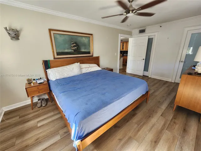 a bed sitting in a spacious bedroom next to a window