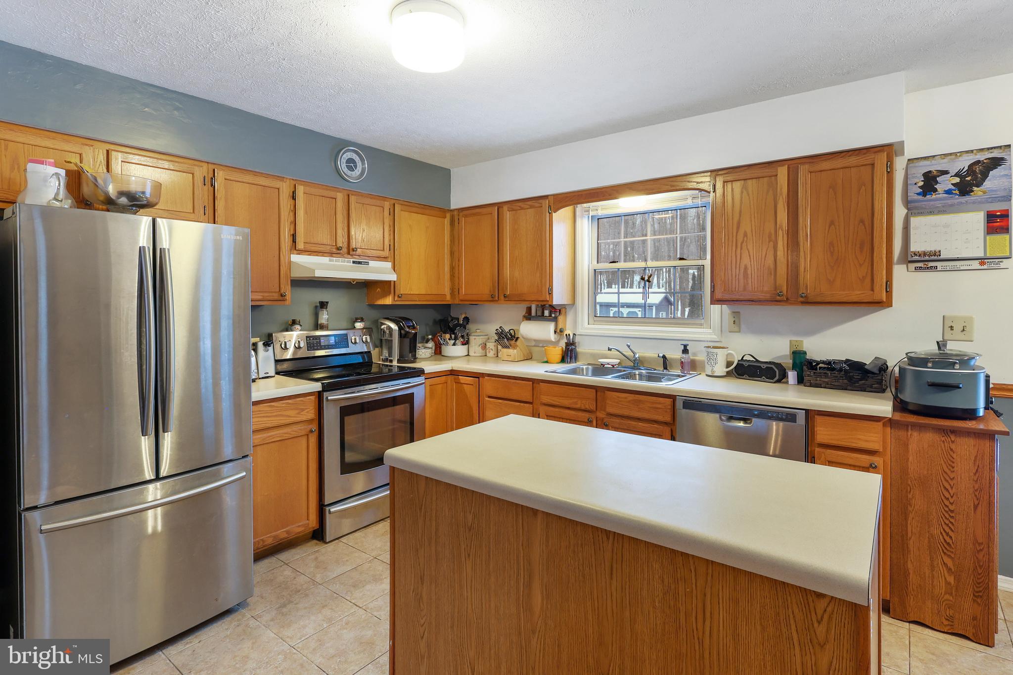 33 Teaberry Ridge Road Lonaconing, MD 21539 - Photo 14 of 101 a kitchen with stainless steel appliances a refrigerator sink and cabinets
