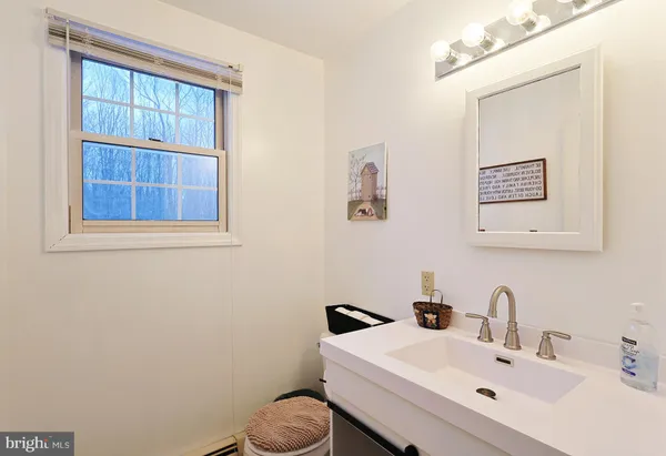 a bedroom with a bed and a dresser with windows