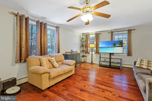 a living room with furniture and a flat screen tv