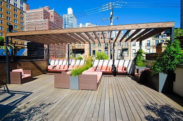 21 West Goethe Street, Unit 11D Chicago, IL 60610 - Photo 6 of 10 a view of a roof deck with wooden floor and outdoor seating