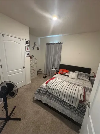 a bedroom with a bed and cabinets
