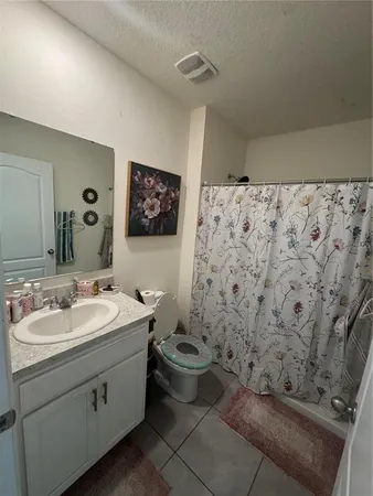 a bathroom with a sink toilet and a mirror