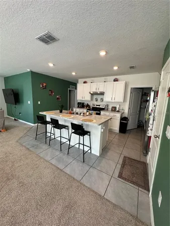 a kitchen with stainless steel appliances kitchen island granite countertop a sink and cabinets