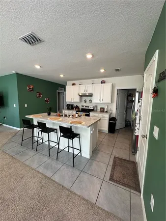 a kitchen with a table and chairs