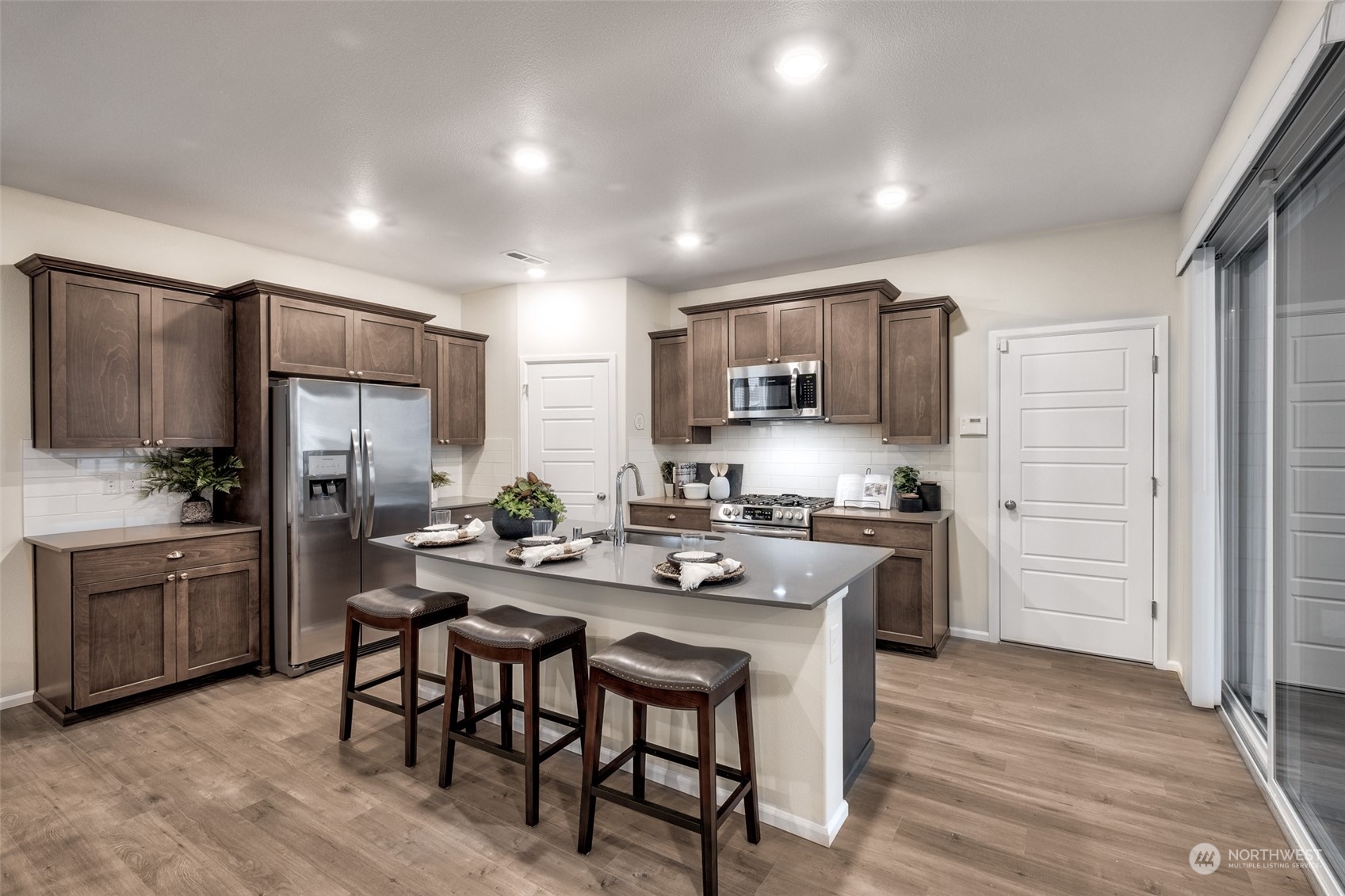 1611 Sultan Basin Road, Unit 1166 Sultan, WA 98294 - Photo 4 of 18 a kitchen with kitchen island granite countertop wooden cabinets and stainless steel appliances