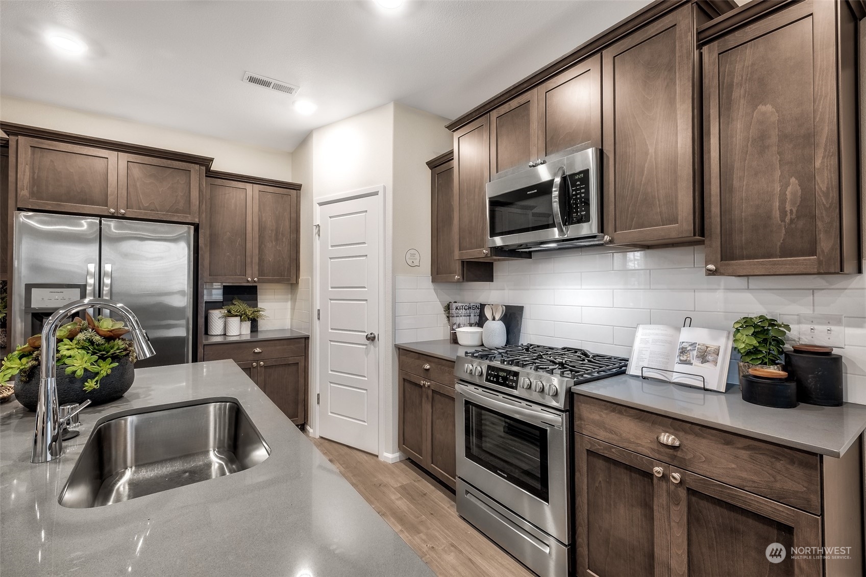 1611 Sultan Basin Road, Unit 1166 Sultan, WA 98294 - Photo 6 of 18 a kitchen with stainless steel appliances a sink a microwave a sink and refrigerator