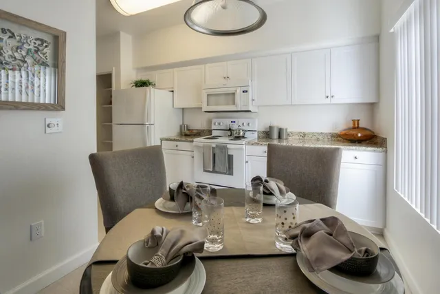 a kitchen with stainless steel appliances granite countertop a sink and a stove