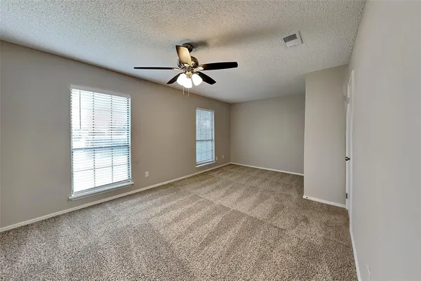 a view of a livingroom with a ceiling fan and window