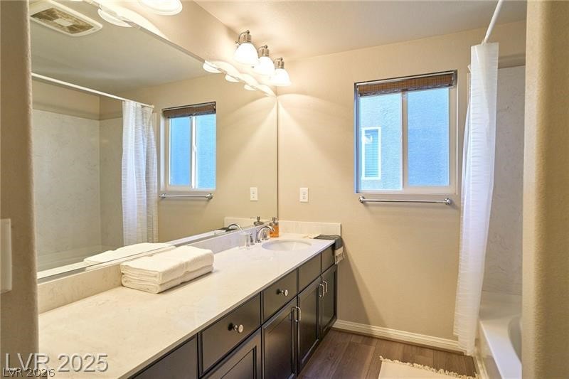6302 Jackson Spring Road Las Vegas, NV 89118 - Photo 16 of 23 Ample counter space defines this well-appointed bathroom, featuring a wide mirror and practical vanity.