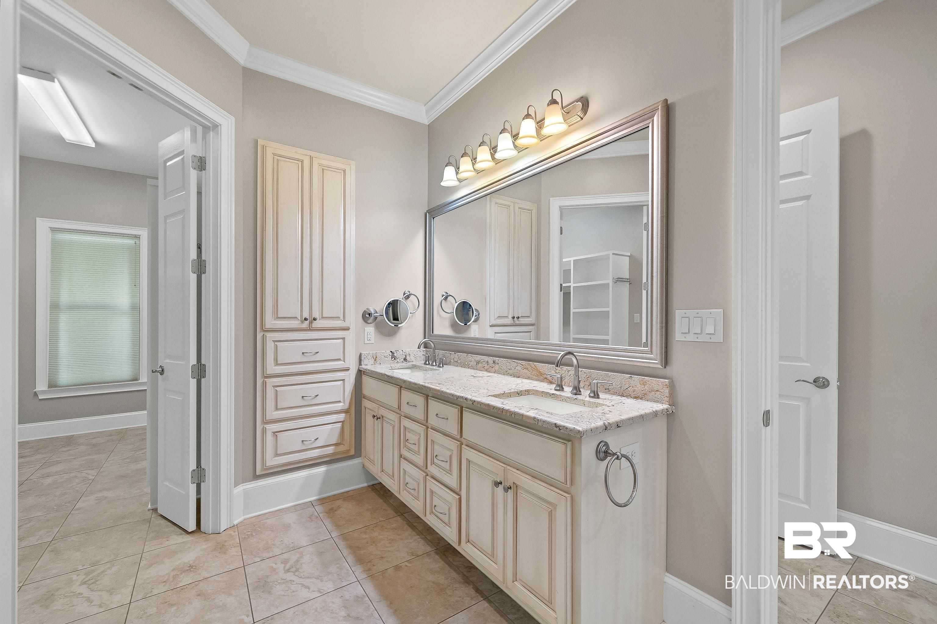 17663 Burwick Loop Fairhope, AL 36532 - Photo 28 of 41 Bathroom with vanity, crown molding, and tile patterned floors