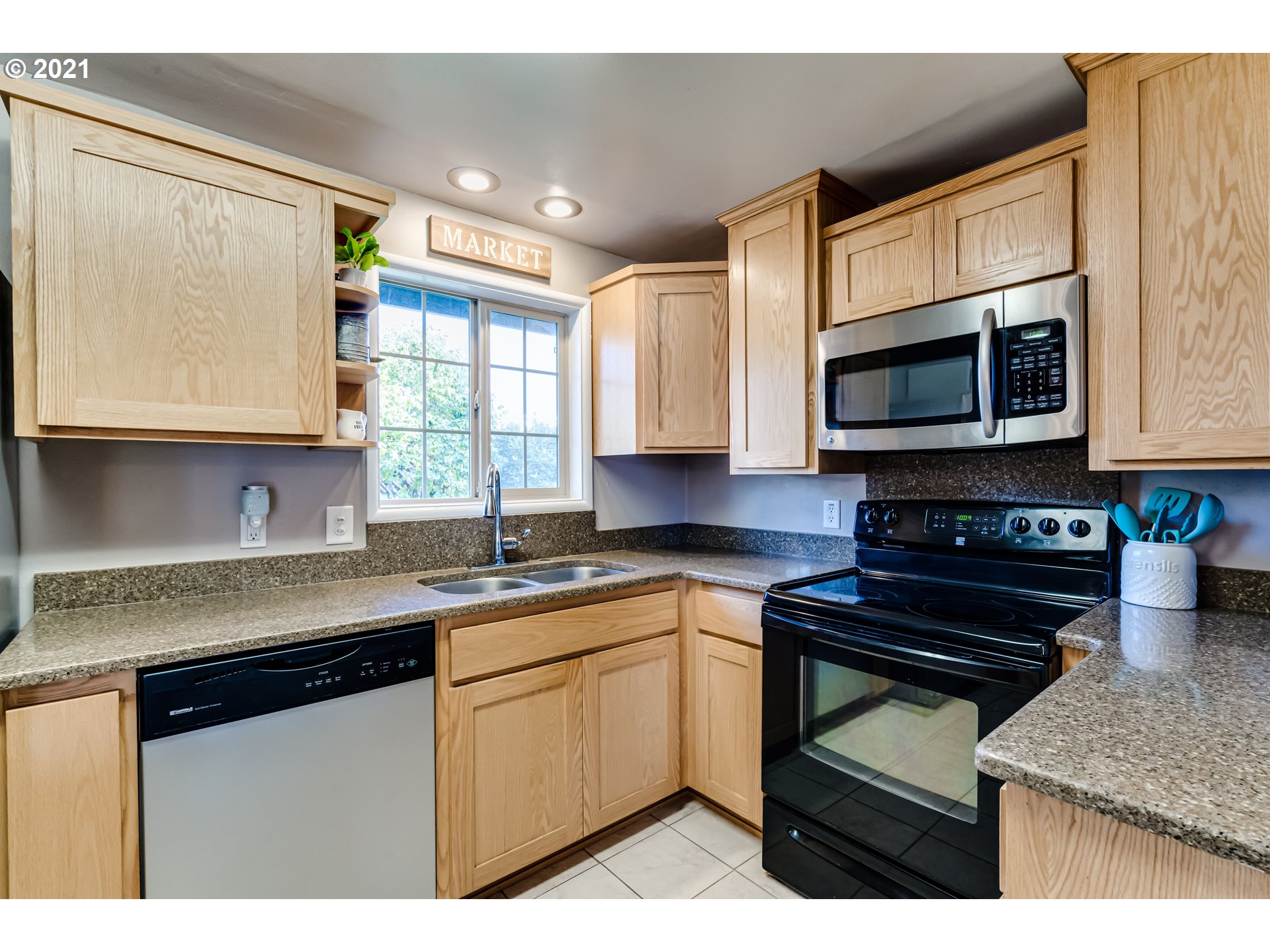 2488 37th Street Springfield, OR 97477 - Photo 9 of 32 a kitchen with stainless steel appliances granite countertop a sink stove and microwave