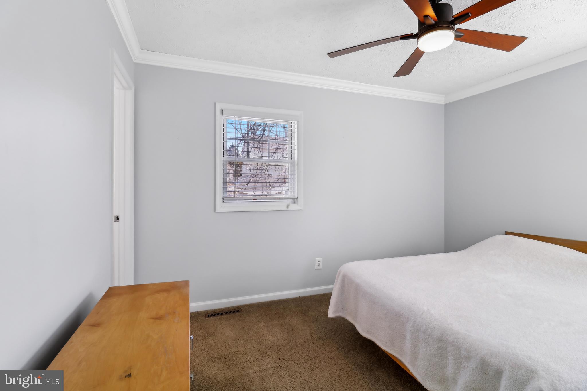 1809 Keymar Road Edgewater, MD 21037 - Photo 15 of 49 a bedroom with a bed and a ceiling fan