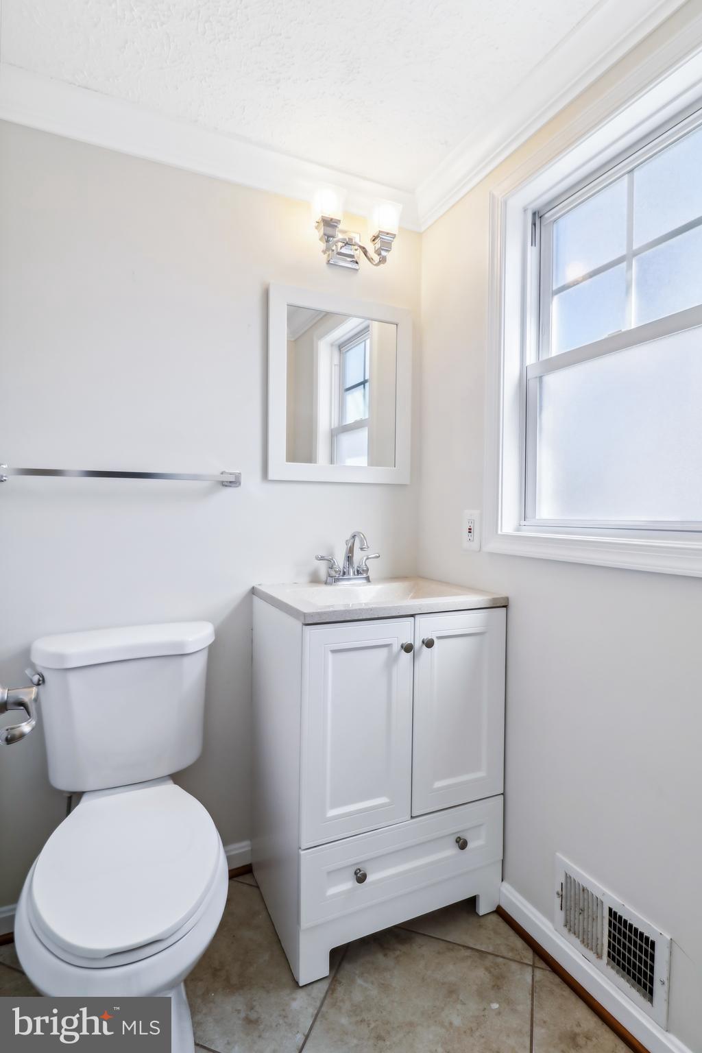 1809 Keymar Road Edgewater, MD 21037 - Photo 18 of 49 a bathroom with a toilet a sink and mirror
