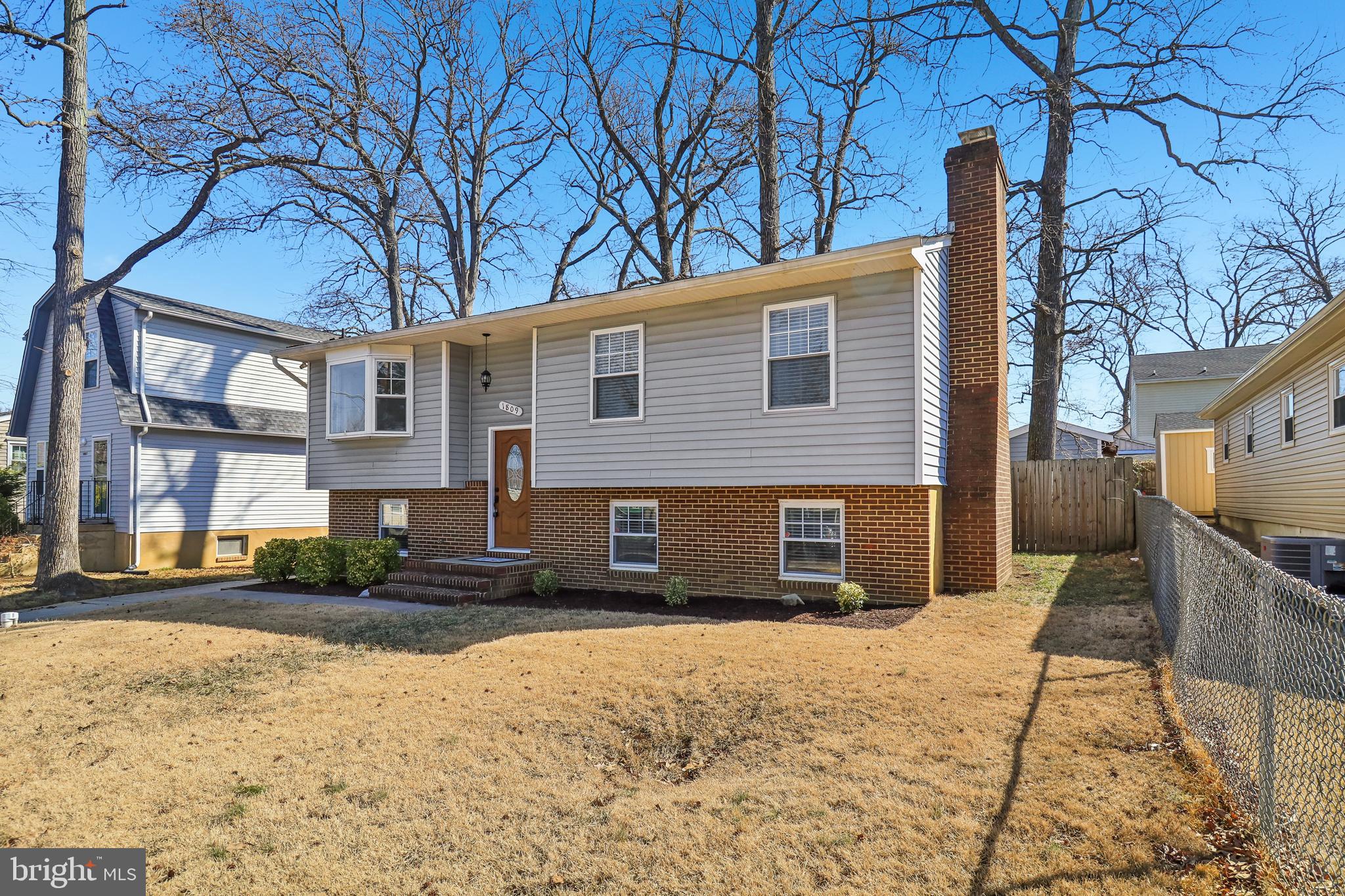 1809 Keymar Road Edgewater, MD 21037 - Photo 2 of 49 a front view of a house with a yard and garage