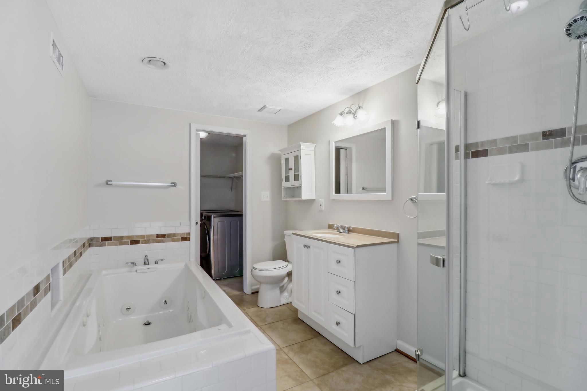 1809 Keymar Road Edgewater, MD 21037 - Photo 29 of 49 a bathroom with a bathtub sink and mirror