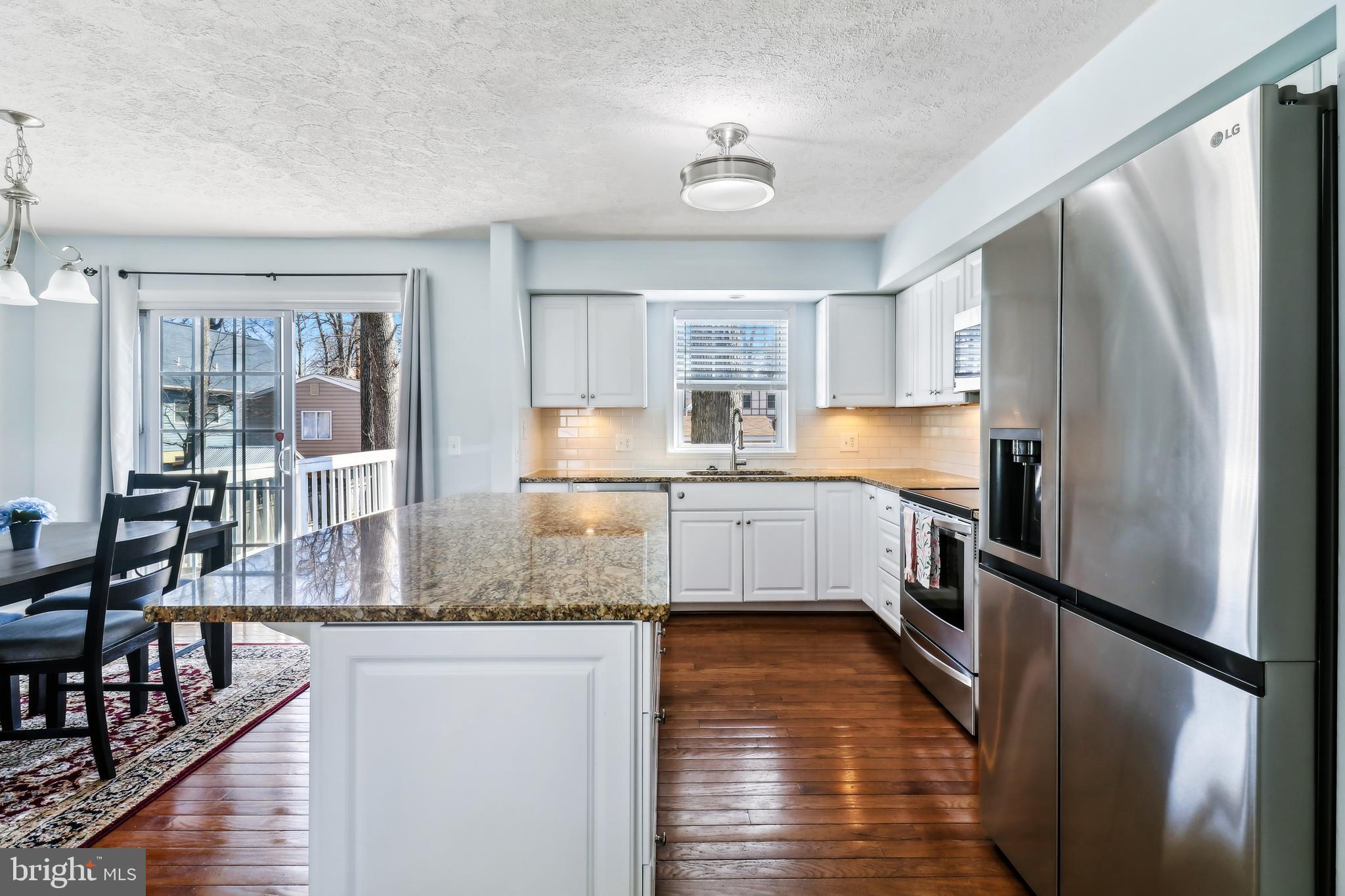 1809 Keymar Road Edgewater, MD 21037 - Photo 8 of 49 a kitchen with stainless steel appliances granite countertop a refrigerator a stove and a sink with cabinets