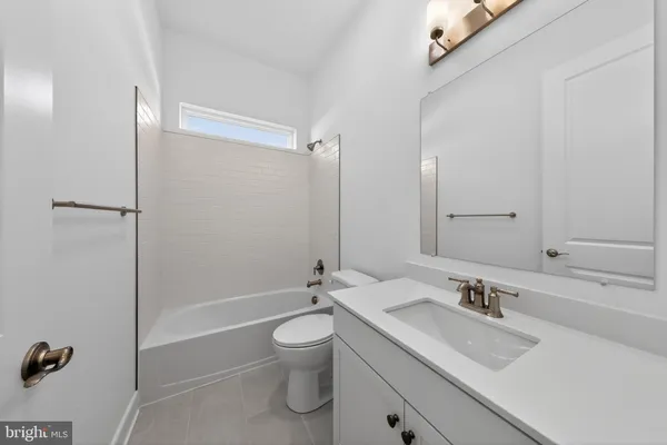 a bathroom with a bathtub and a window