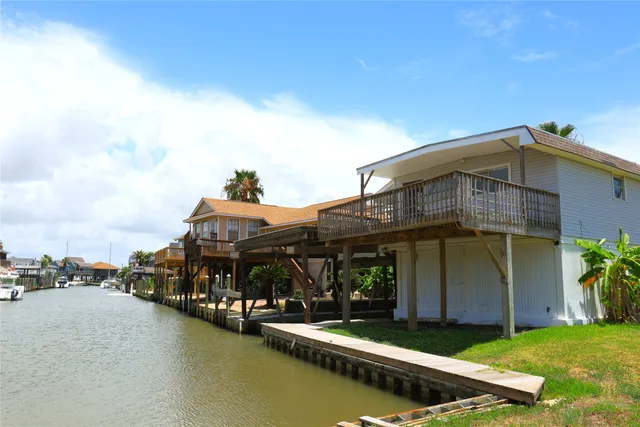 a view of a porch with chairs and floor to ceiling window