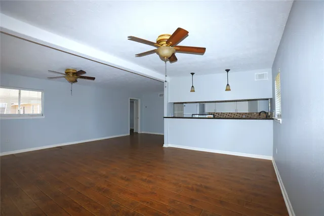 a kitchen with a sink a refrigerator and cabinets
