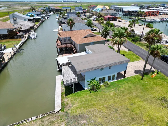a aerial view of a house with a garden and lake view
