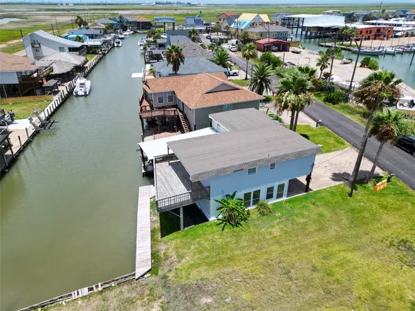 a aerial view of a house with a garden and lake view