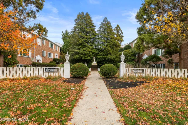 a view of a pathway with a wrought fence