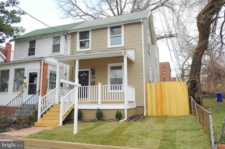 4642 Hayes Street Northeast Washington, DC 20019 - Photo 1 of 1 a front view of a house with a yard glass top table and chairs