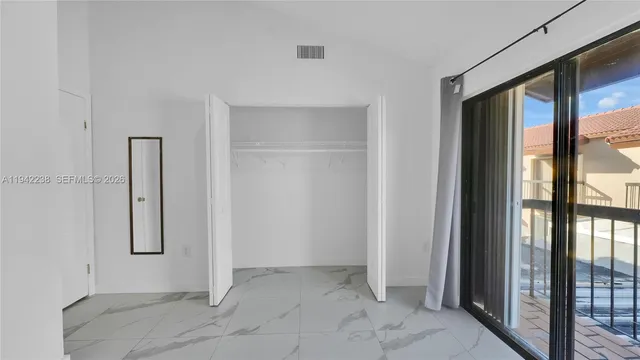a bathroom with a sink vanity granite toilet and a shower