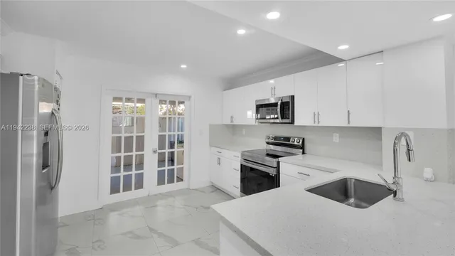 a kitchen with a sink a stove and refrigerator