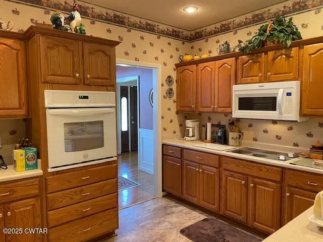 a kitchen with granite countertop a sink and a stove top oven