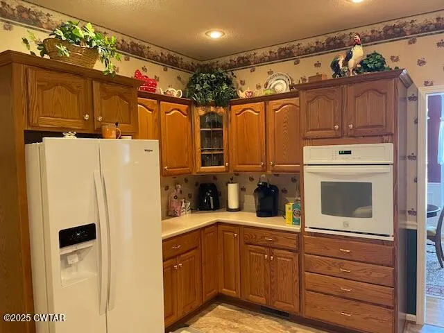a kitchen with stainless steel appliances granite countertop a refrigerator and a cabinets