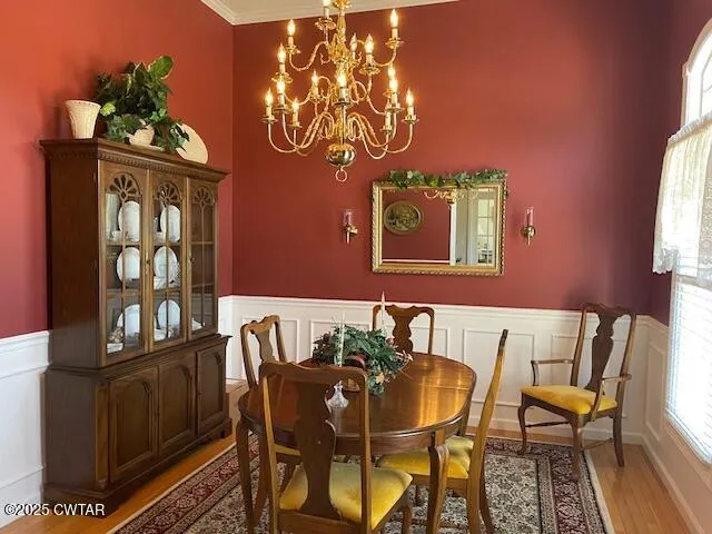 a view of a dining room with furniture and chandelier