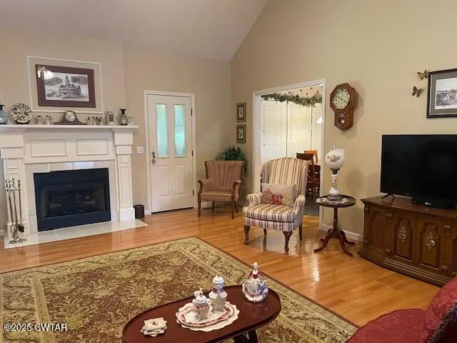 a living room with furniture a flat screen tv and a fireplace