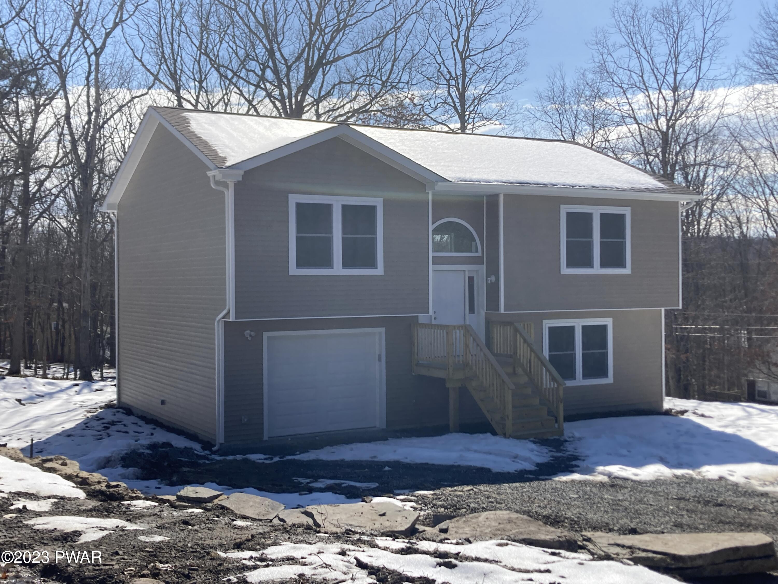 233 Ridge Drive Milford, PA 18337 - Photo 1 of 11 a front view of a house with a yard