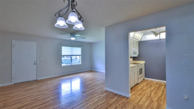 a view of livingroom and kitchen with wooden floor