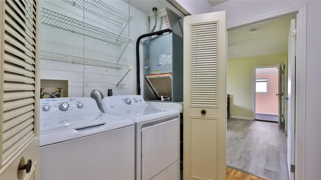 a wooden bench sitting in a room next to a window