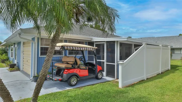 a car parked in front of house with a yard