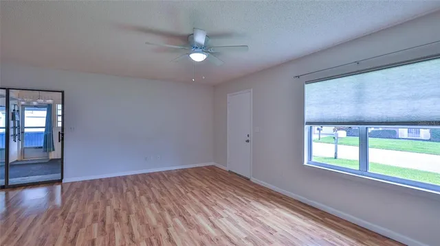 wooden floor in an empty room with a window