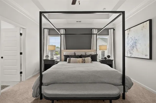 a bedroom with a bed mirror and window