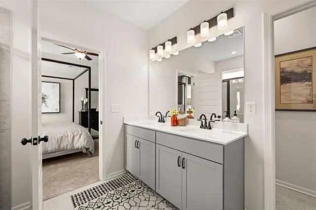 a en suite bathroom with a sink double vanity and a mirror