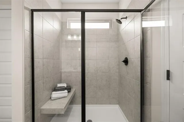 a bathroom with a glass shower door