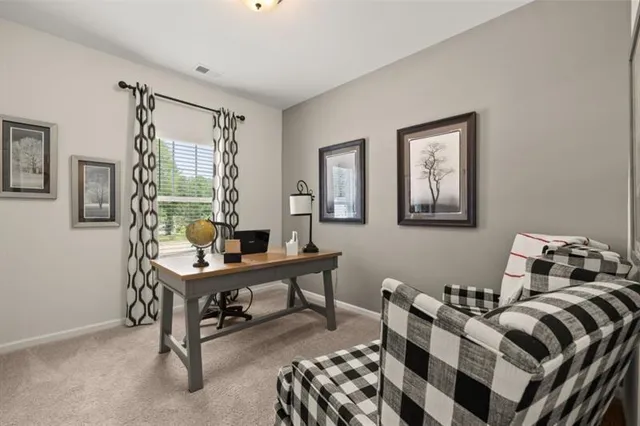 a view of a workspace with furniture