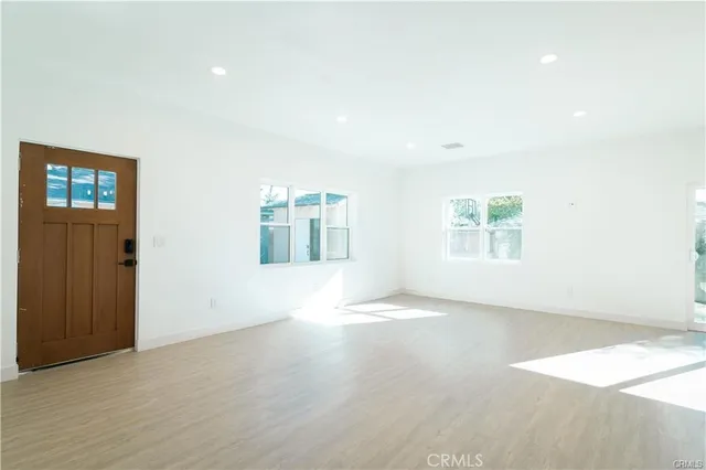 an empty room with windows and entrance