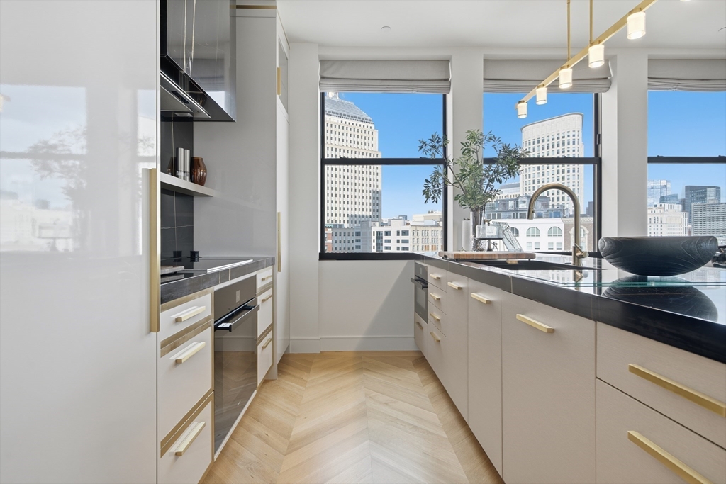 285 Columbus Avenue, Unit PH 805 Boston, MA 02116 - Photo 17 of 42 a large kitchen with stainless steel appliances granite countertop a lot of counter space and a sink