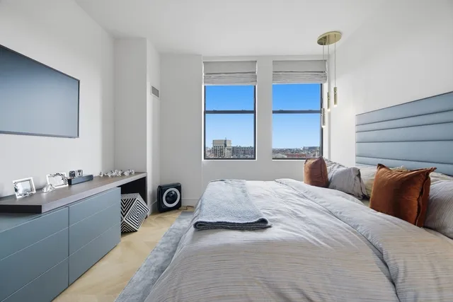 a bedroom with a bed and window