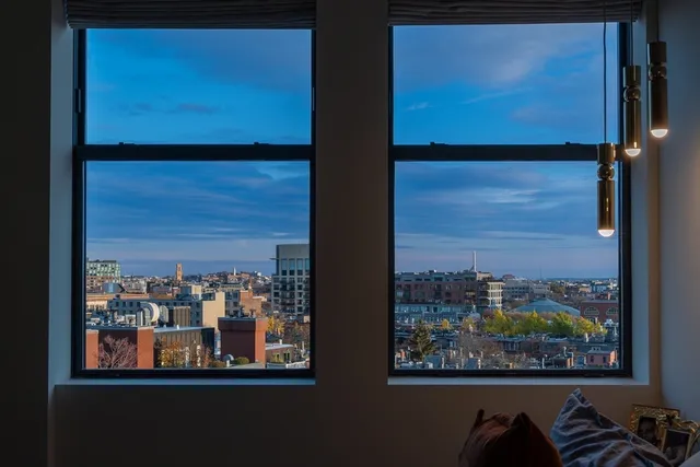 a living room with furniture a rug and a large window