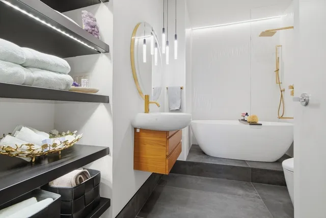 a bedroom with a washing machine and a sink